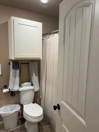 a kitchen with stainless steel appliances kitchen island granite countertop a table chairs and a refrigerator