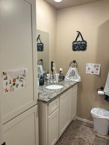 a kitchen with stainless steel appliances kitchen island granite countertop a table chairs and a refrigerator