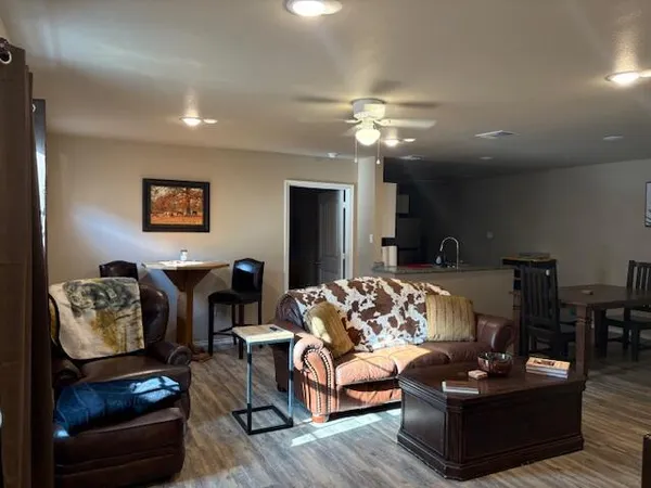 a bathroom with a granite countertop sink and a toilet