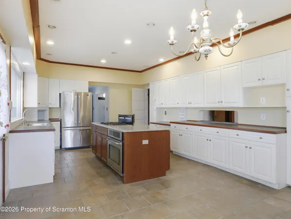 a large kitchen with stainless steel appliances lots of counter space and wooden floor