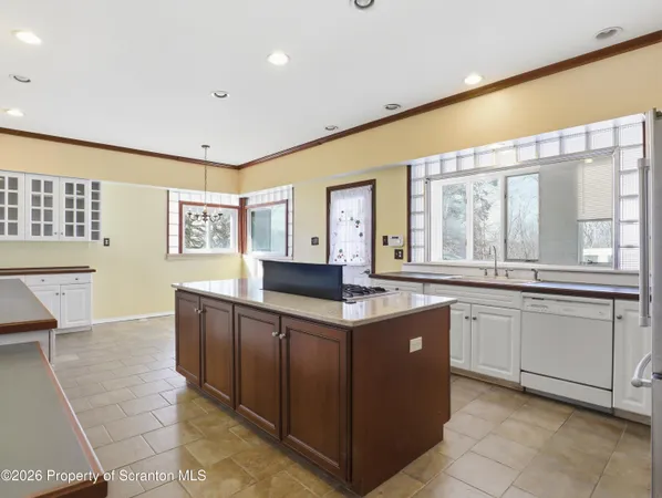 a large kitchen with stainless steel appliances granite countertop a large counter top and a stove