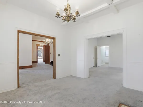 a view of a hallway with a chandelier
