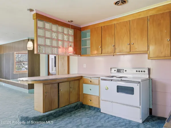 a view of a kitchen with stove and cabinets