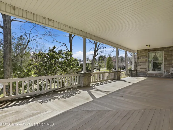 a view of a porch with wooden floor