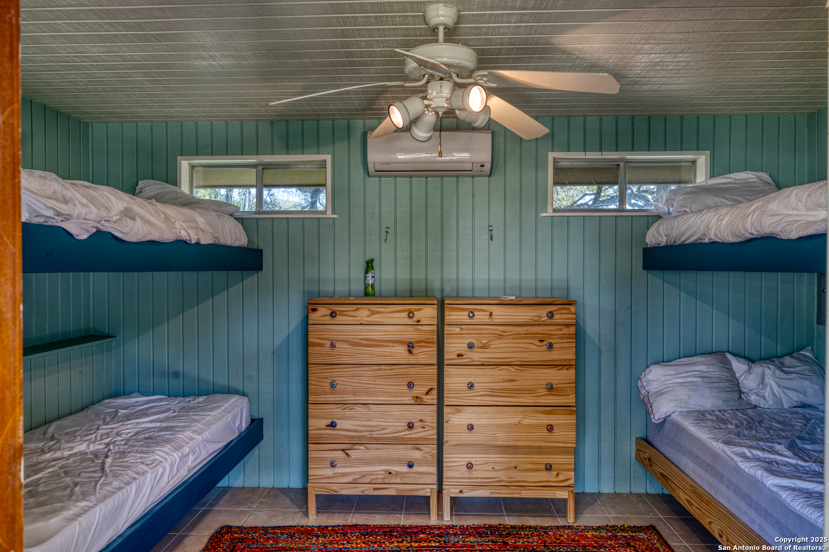 416 Cold Spring River Concan, TX 78838 - Photo 27 of 57 a view of a bedroom with furniture and a window