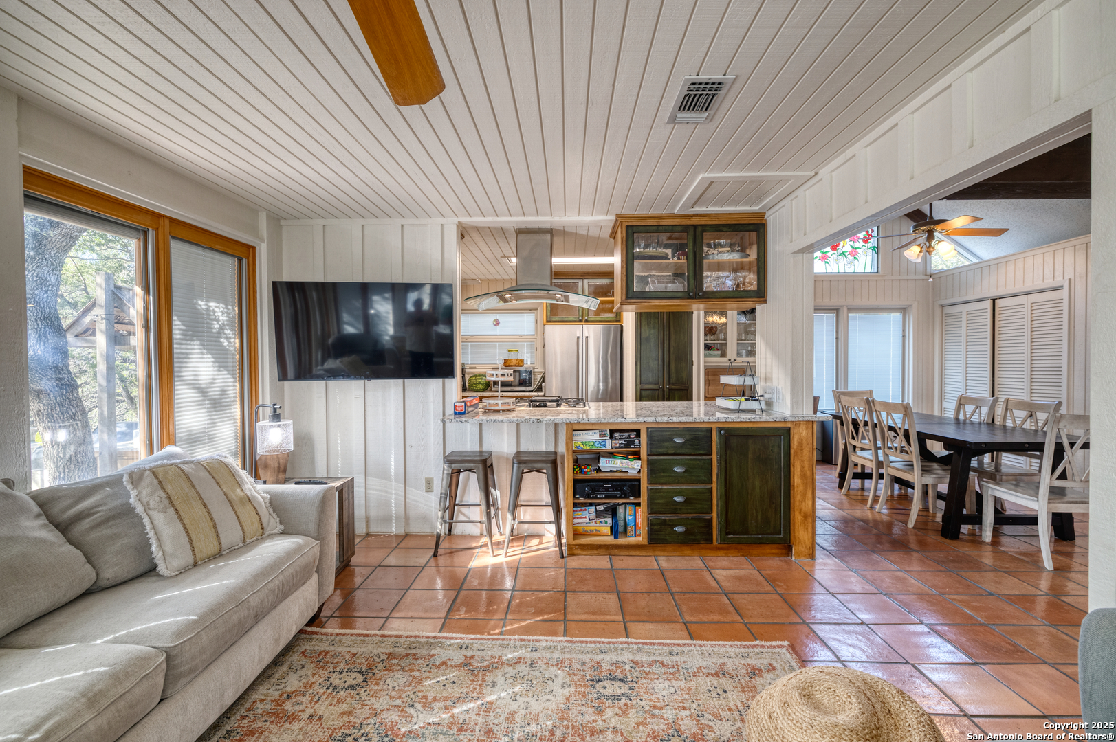 416 Cold Spring River Concan, TX 78838 - Photo 39 of 57 a living room with stainless steel appliances lots of furniture and a flat screen tv
