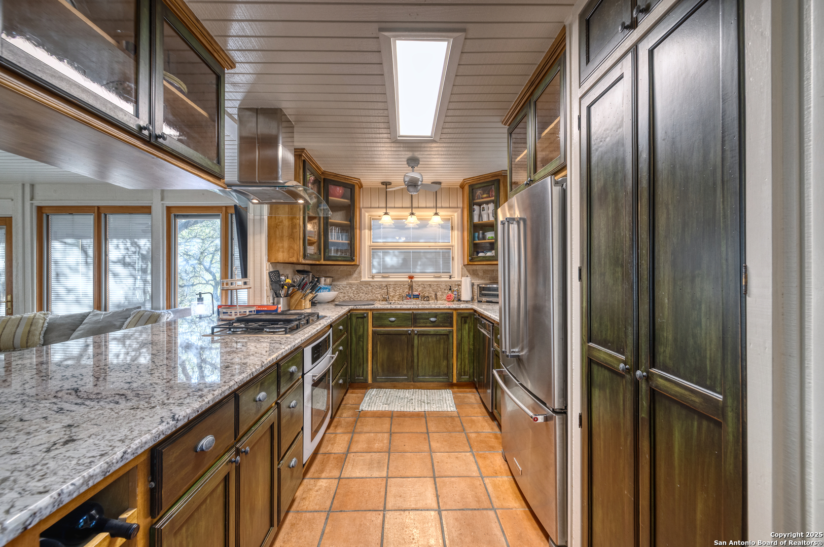416 Cold Spring River Concan, TX 78838 - Photo 40 of 57 a kitchen with stainless steel appliances granite countertop a refrigerator and a sink