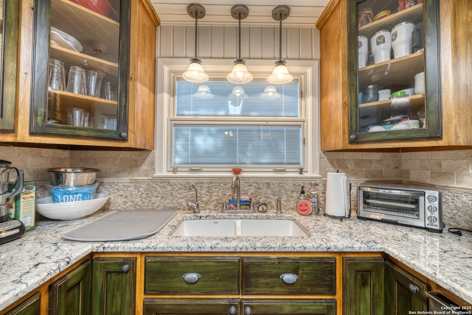 416 Cold Spring River Concan, TX 78838 - Photo 41 of 57 a kitchen with granite countertop stainless steel appliances window and cabinets