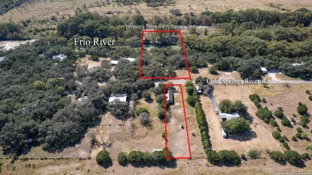 a view of backyard with wooden fence and large trees
