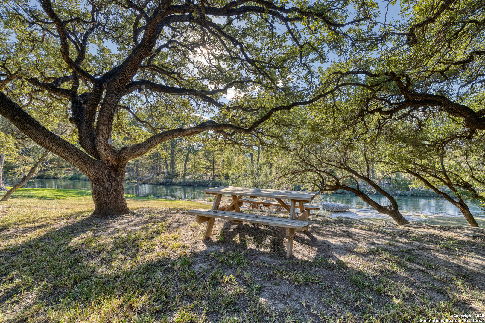 416 Cold Spring River Concan, TX 78838 - Photo 54 of 57 a view of a yard with wooden fence and trees