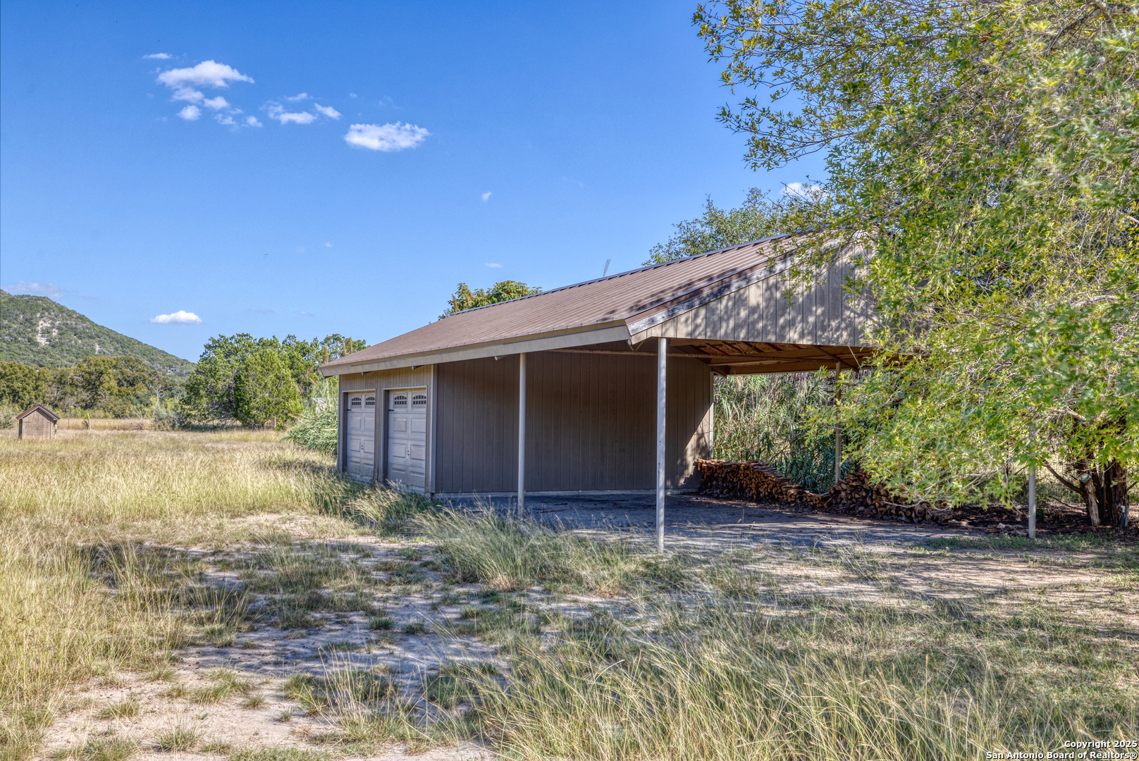 416 Cold Spring River Concan, TX 78838 - Photo 57 of 57 a view of backyard with wooden fence and large trees