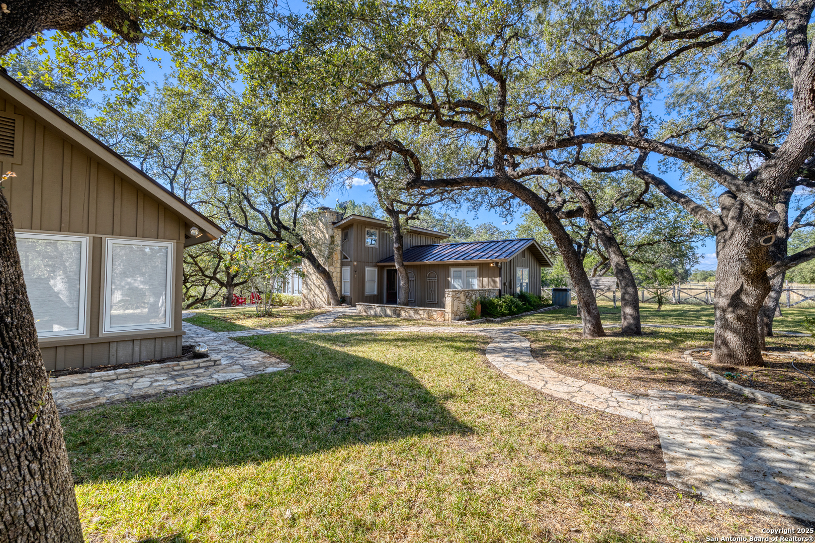 416 Cold Spring River Concan, TX 78838 - Photo 9 of 57 a view of a house with a yard and large tree