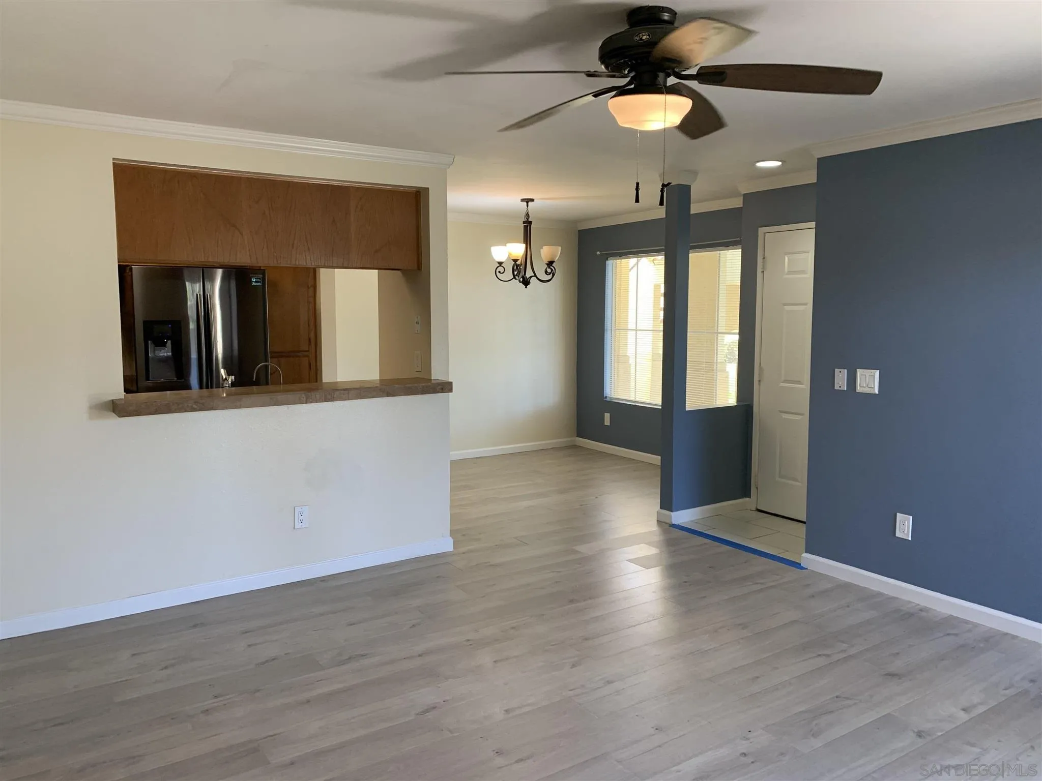 707 Brookstone Road, Unit 101 Chula Vista, CA 91913 - Photo 1 of 7 a view of an empty room with wooden floor and a ceiling fan