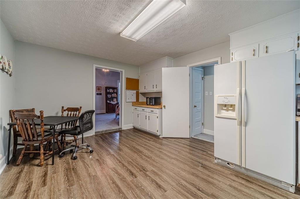 284 Covington Street Loganville, GA 30052 - Photo 11 of 55 a view of a dining room with furniture and wooden floor