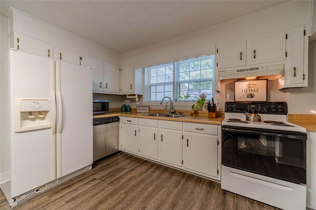 284 Covington Street Loganville, GA 30052 - Photo 12 of 55 a kitchen with cabinets appliances and a window