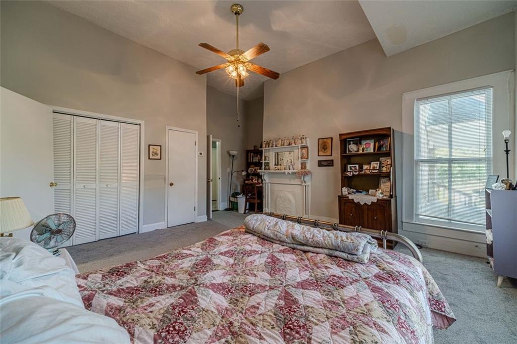 284 Covington Street Loganville, GA 30052 - Photo 17 of 55 a bedroom with a large bed and a chandelier