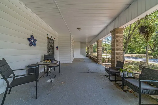 a living room with furniture a flat screen tv and a ceiling fan