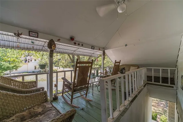 a bedroom with a bed a dresser and a chandelier