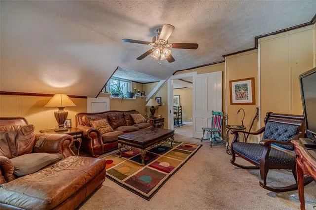 a spacious bedroom with a bed a dresser and potted plant