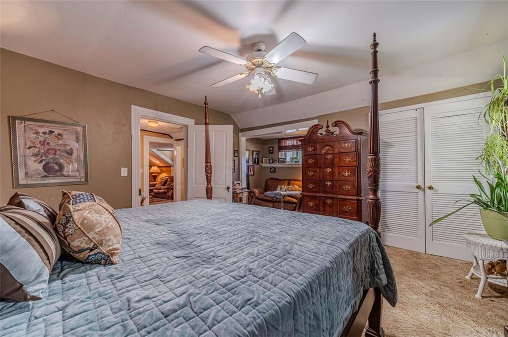 284 Covington Street Loganville, GA 30052 - Photo 25 of 55 a spacious bedroom with a bed a dresser and potted plant