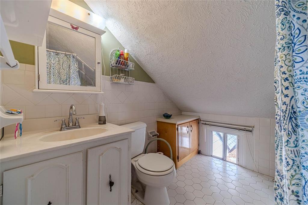 284 Covington Street Loganville, GA 30052 - Photo 26 of 55 a bathroom with a toilet sink and mirror