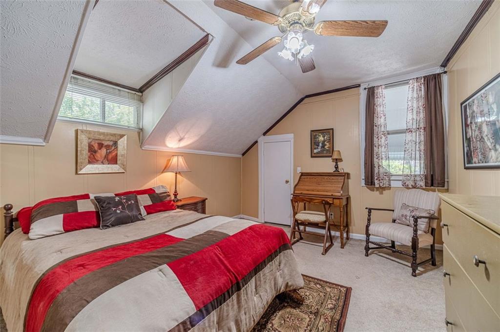 284 Covington Street Loganville, GA 30052 - Photo 27 of 55 a bedroom with a bed and a chandelier