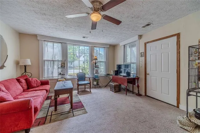 a bed sitting in a bedroom next to a bathroom