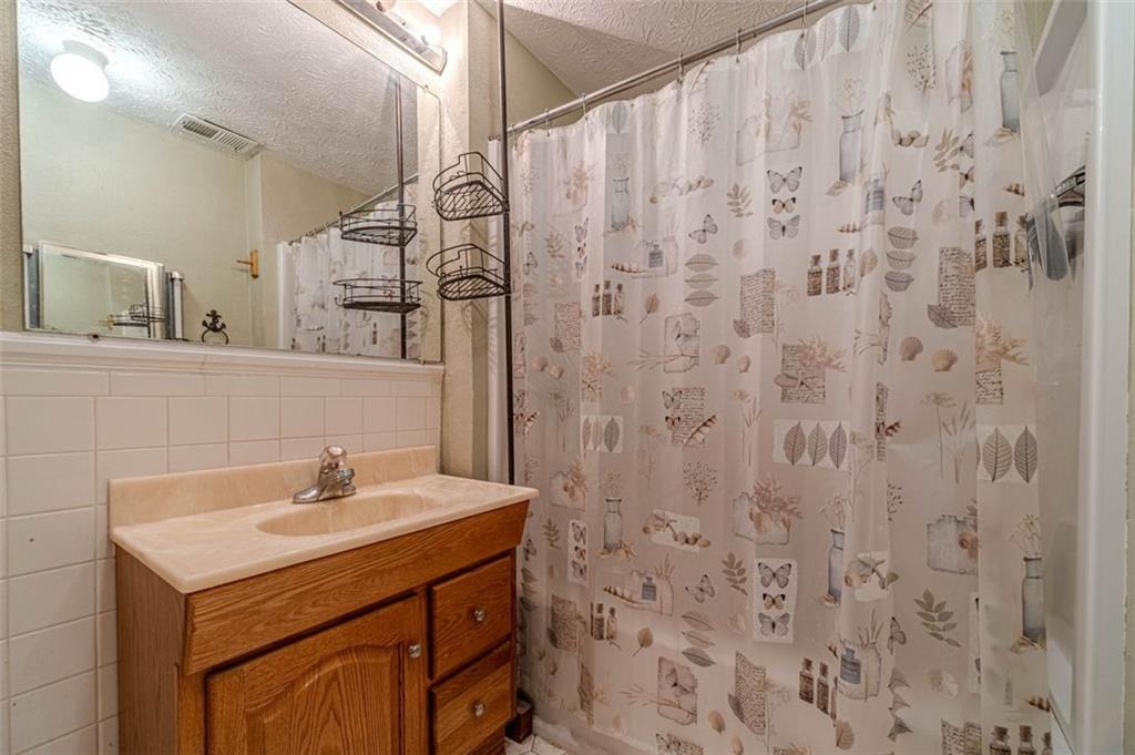284 Covington Street Loganville, GA 30052 - Photo 37 of 55 a bathroom with a sink and a mirror