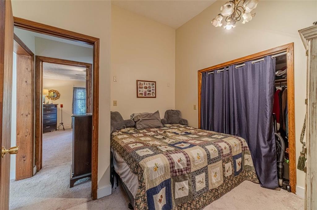 284 Covington Street Loganville, GA 30052 - Photo 39 of 55 a bed sitting in a bedroom next to a bathroom
