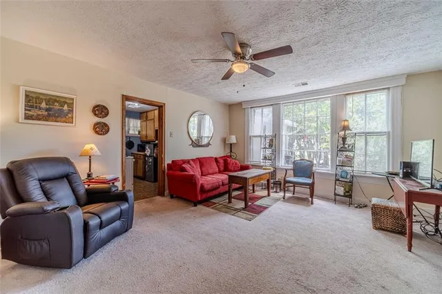 a view of a kitchen with a dining table chairs and refrigerator