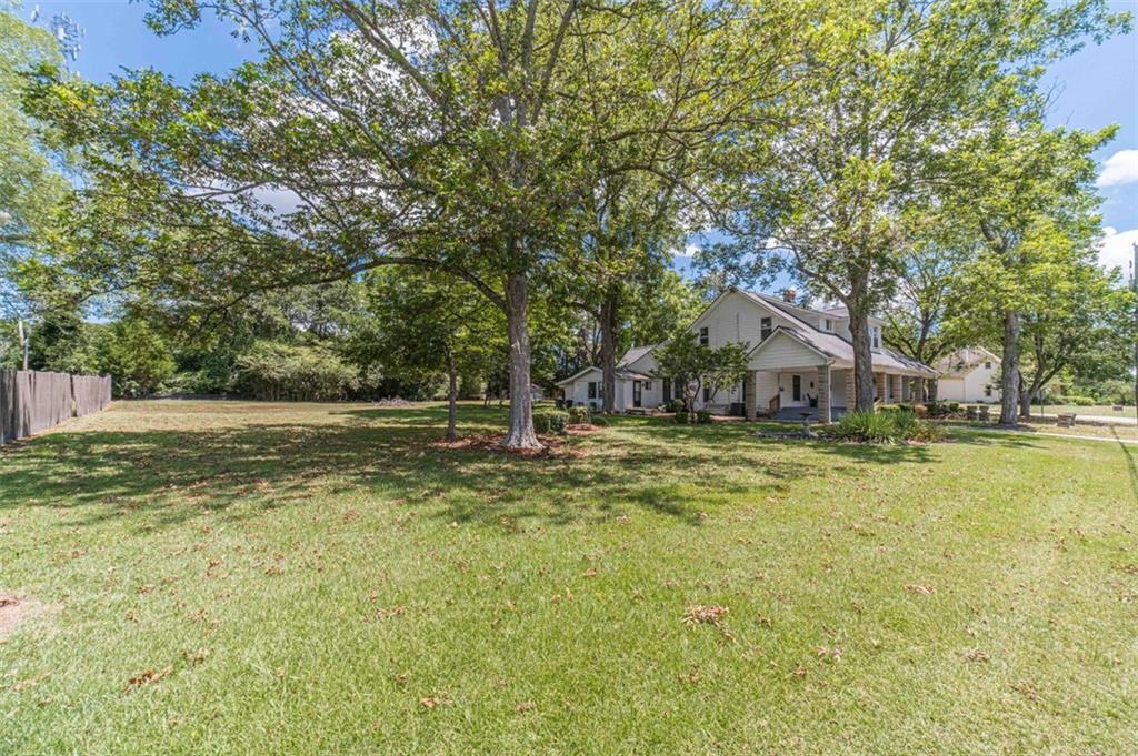 284 Covington Street Loganville, GA 30052 - Photo 54 of 55 a view of a house with pool and trees