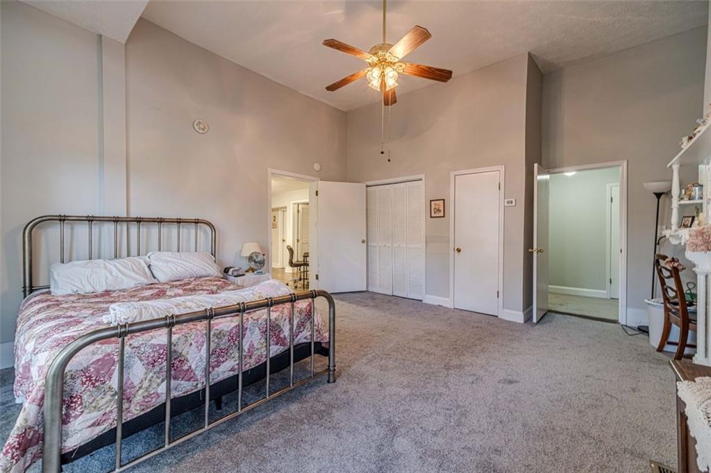 284 Covington Street Loganville, GA 30052 - Photo 7 of 55 a bedroom with a bed and a chandelier