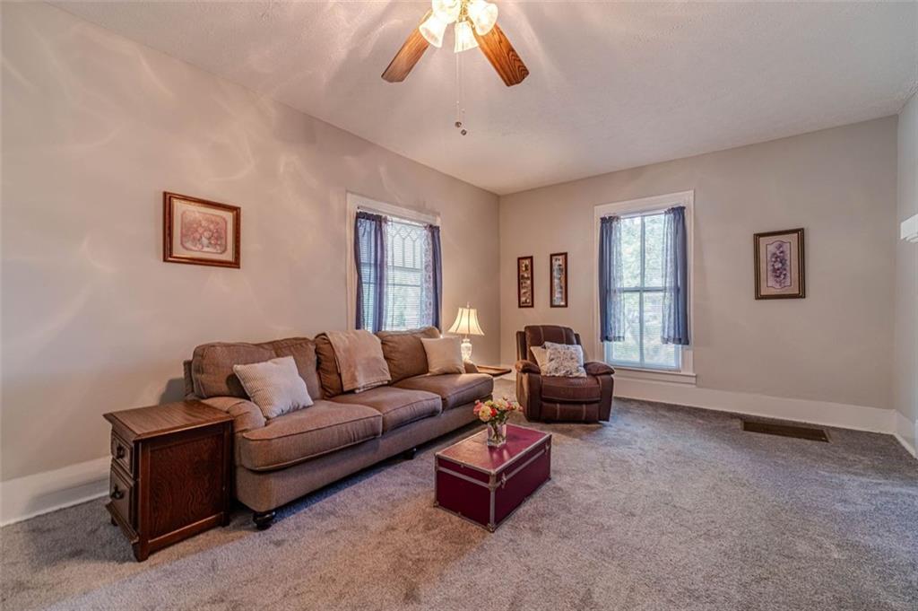 284 Covington Street Loganville, GA 30052 - Photo 8 of 55 a living room with furniture and a chandelier