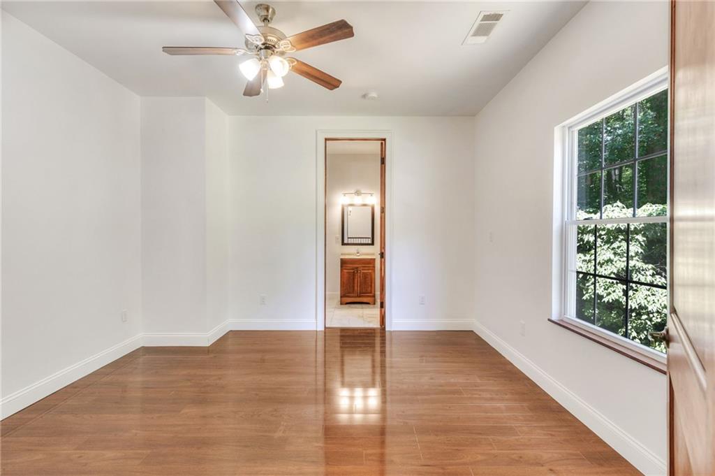 11070 Buchanan Highway Temple, GA 30179 - Photo 20 of 32 a view of empty room with wooden floor and fan