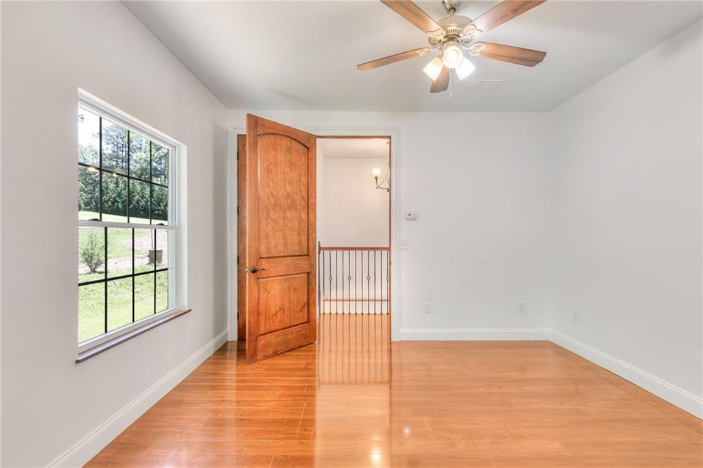 11070 Buchanan Highway Temple, GA 30179 - Photo 21 of 32 wooden floor in an empty room with a window