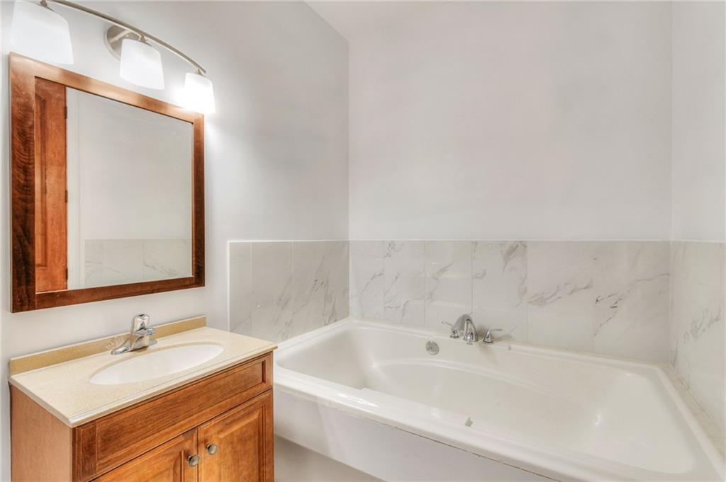11070 Buchanan Highway Temple, GA 30179 - Photo 23 of 32 a bathroom with a tub sink and mirror