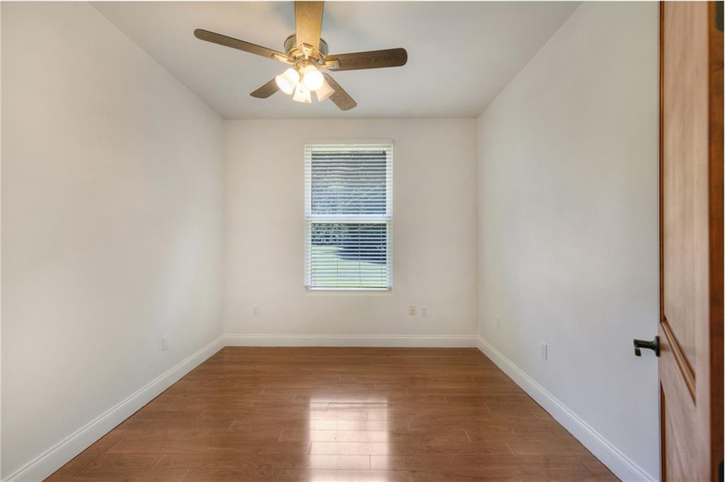 11070 Buchanan Highway Temple, GA 30179 - Photo 26 of 32 an empty room with a chandelier fan and windows