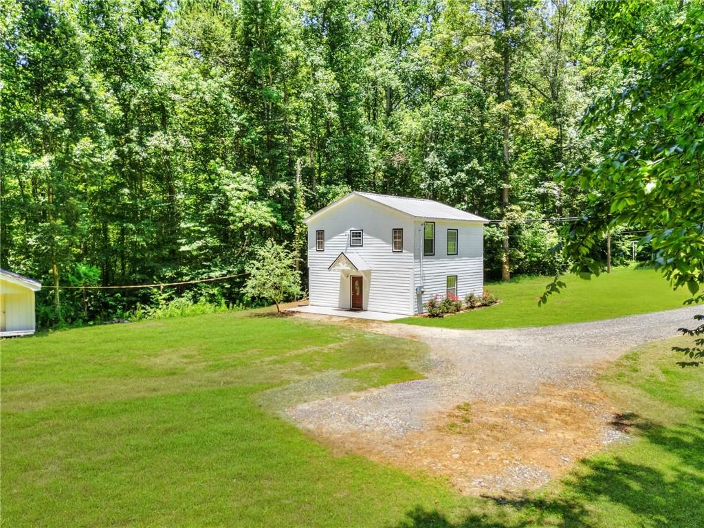 11070 Buchanan Highway Temple, GA 30179 - Photo 3 of 32 a front view of a house with a garden and yard