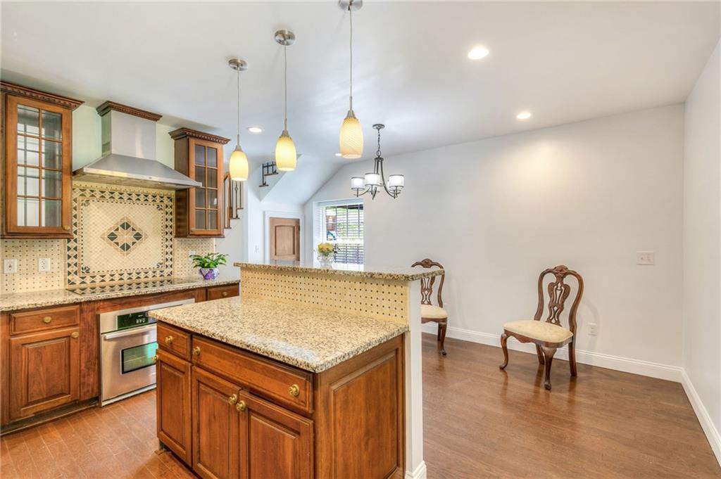 11070 Buchanan Highway Temple, GA 30179 - Photo 6 of 32 a view of a kitchen area with furniture and wooden floor
