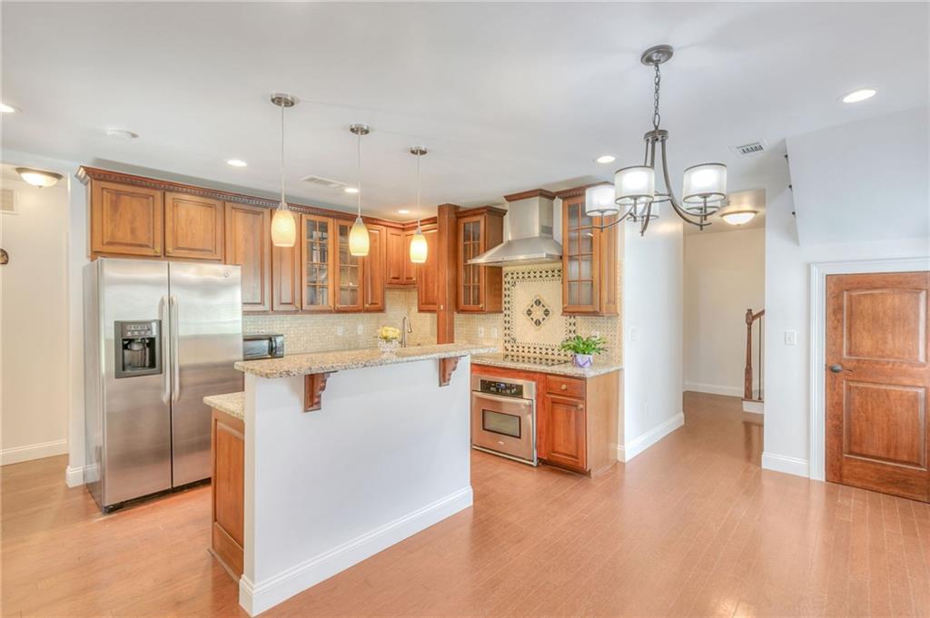 11070 Buchanan Highway Temple, GA 30179 - Photo 7 of 32 a large white kitchen with a refrigerator a stove a sink and a chandelier