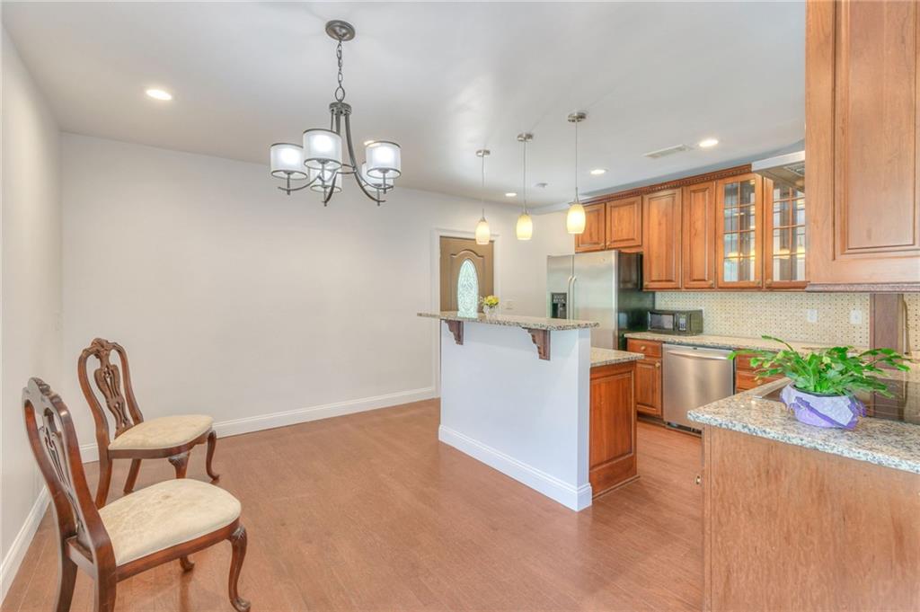 11070 Buchanan Highway Temple, GA 30179 - Photo 8 of 32 a living room with furniture a chandelier and kitchen view