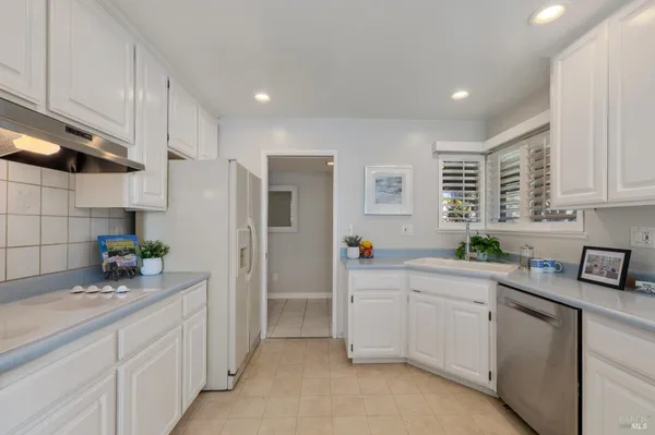 a kitchen with a sink cabinets and window
