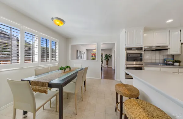 a view of a dining room with furniture and a kitchen