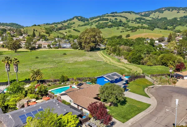 an aerial view of a house with a yard