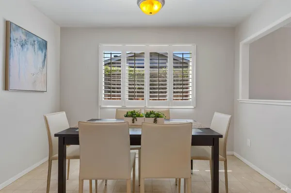 a view of a dining room with furniture and window