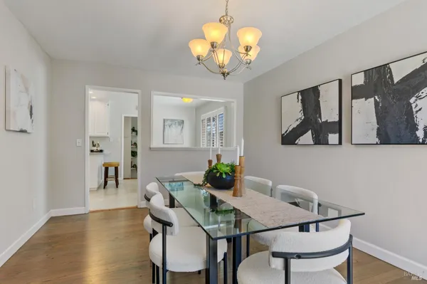 a view of a dining room with furniture wooden floor and chandelier