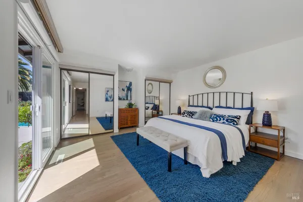 a bedroom with a large bed and a chandelier