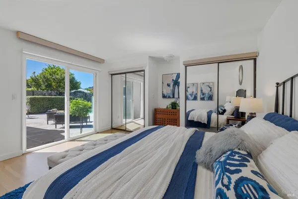 a bedroom with a bed and a large window