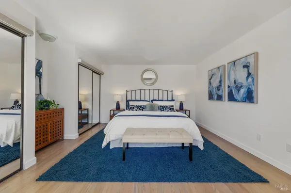 a bedroom with a bed lamp and a table