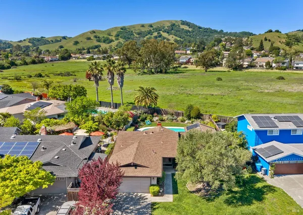an aerial view of a houses with a yard